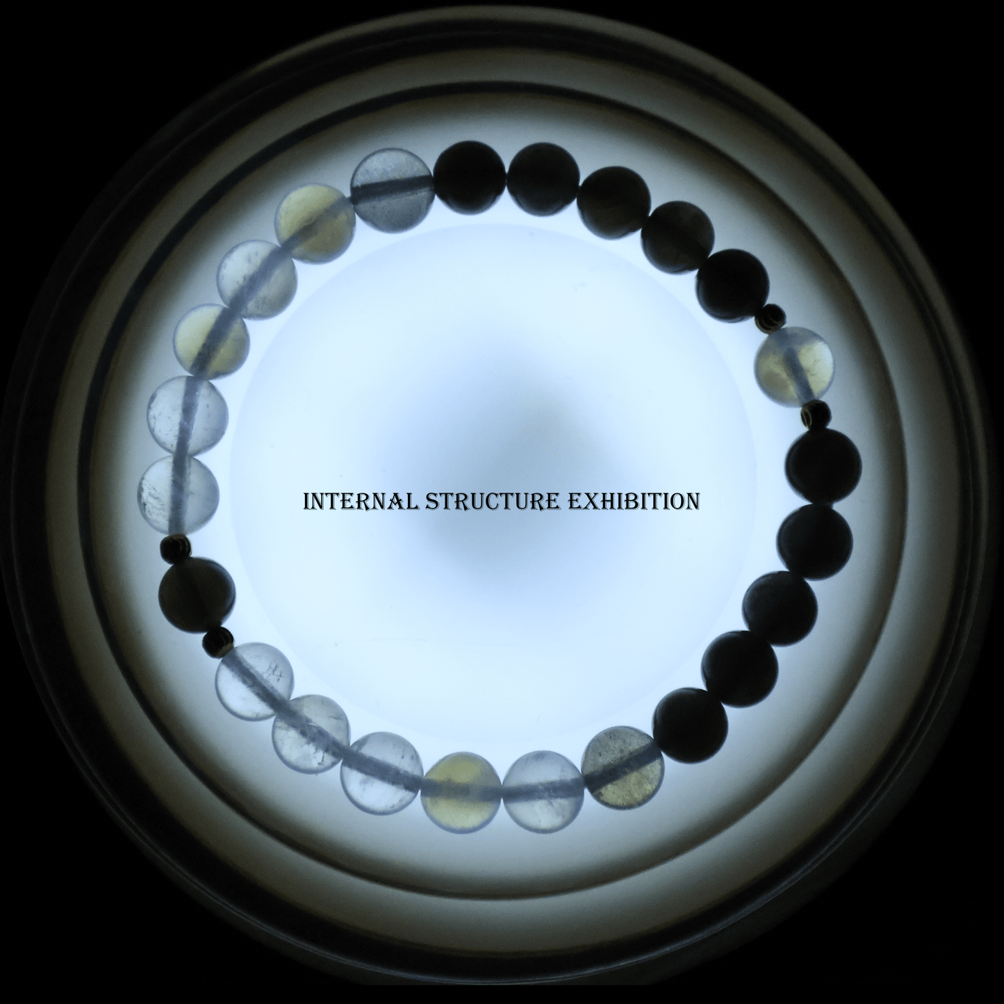 Black & Blue & Gray Moonstone Bracelet I on white ground, which shows its internal structure