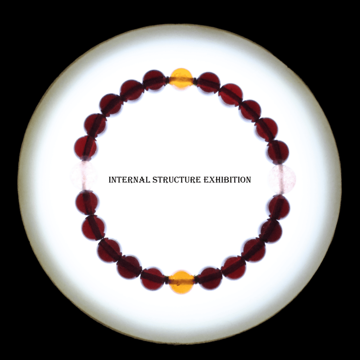 Red & Orange Garnet Bracelet I on white background, which shows internal structure