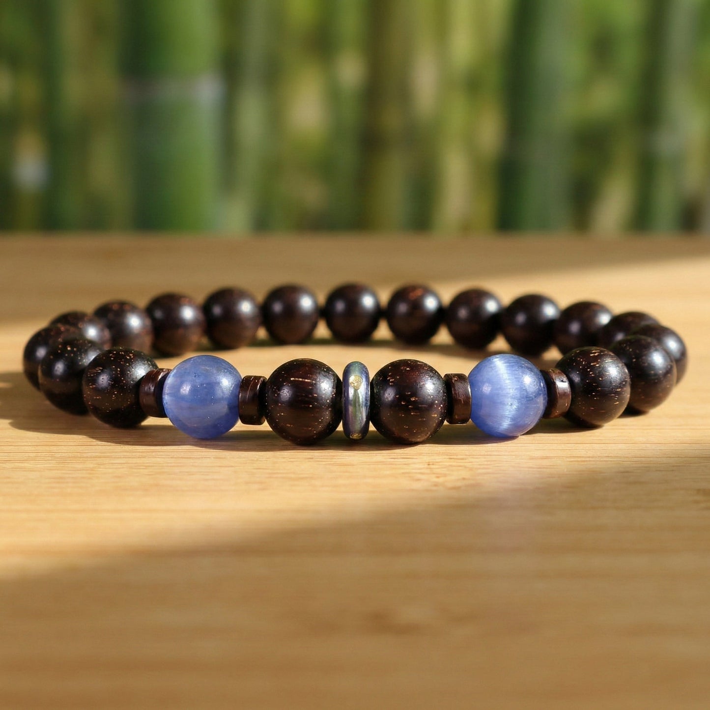 Red Sandalwood & Kyanite Bracelet I on wood desk under the sunshine light of bamboo forest