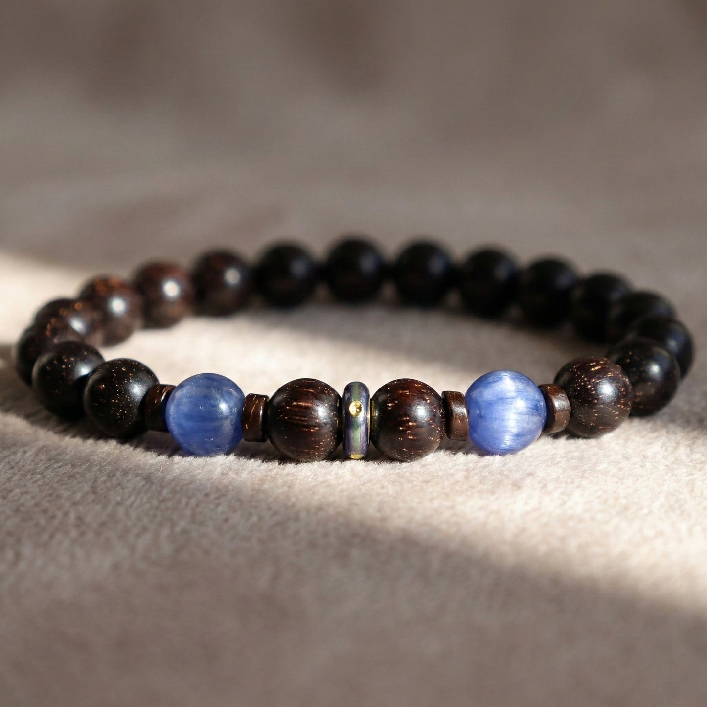 Red Sandalwood & Kyanite Bracelet I on desk under the sunshine light